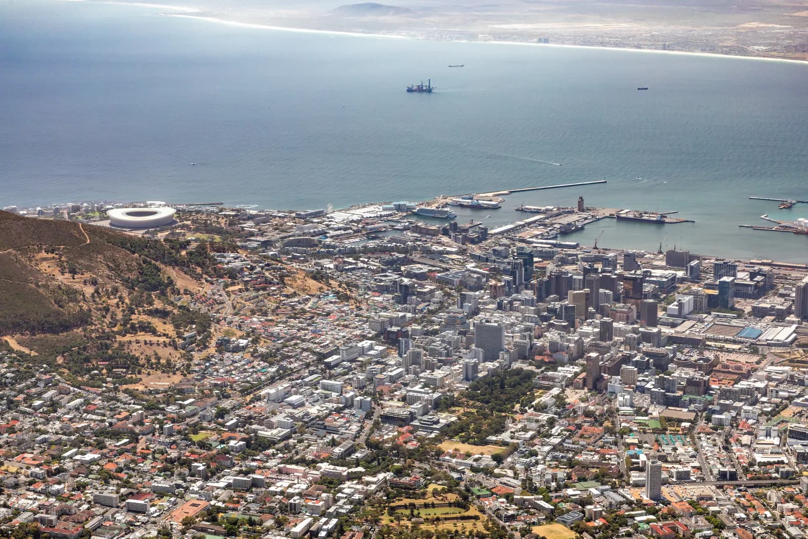 Cape Town's city centre seen from Table Mountain, with the harbour and the V&A Waterfront on the bay and the stadium at Green Point on the left