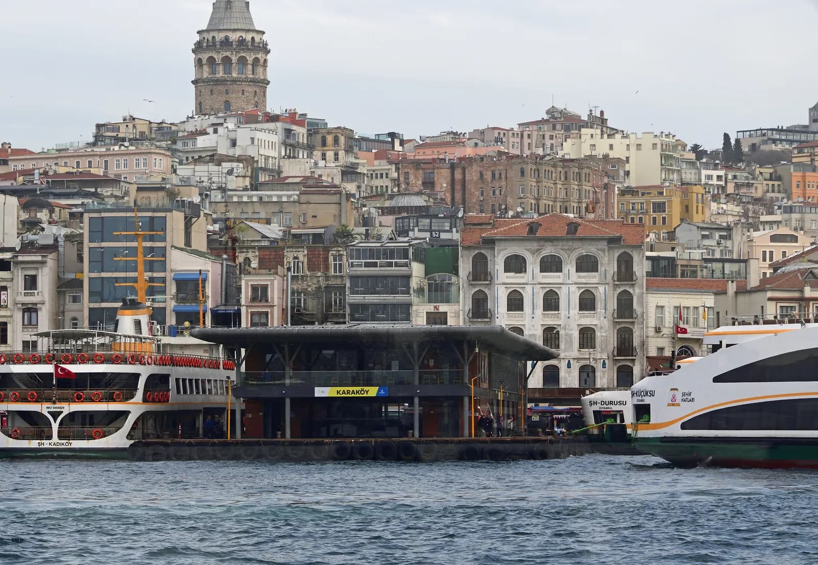 City ferries at the Karaköy pier, with the old buildings of Galata climbing the hill to Galata Tower