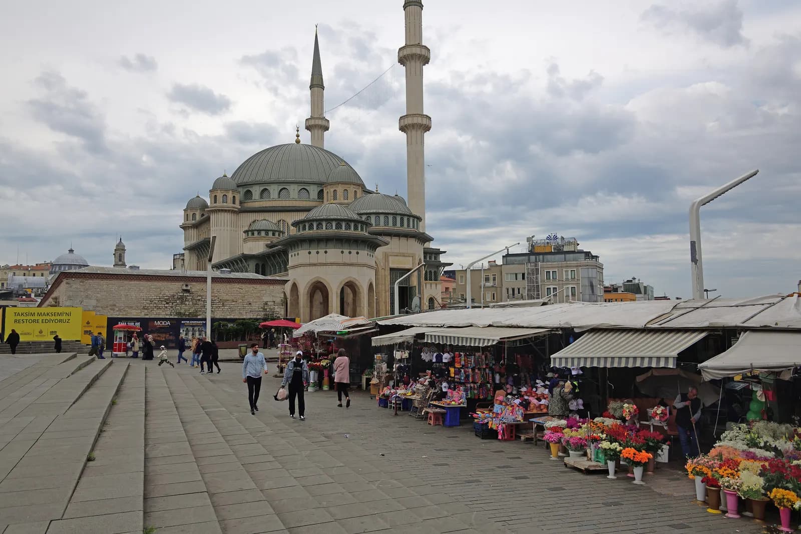 The Taksim Mosque above Taksim Square, with flower and souvenir stalls along the paved square