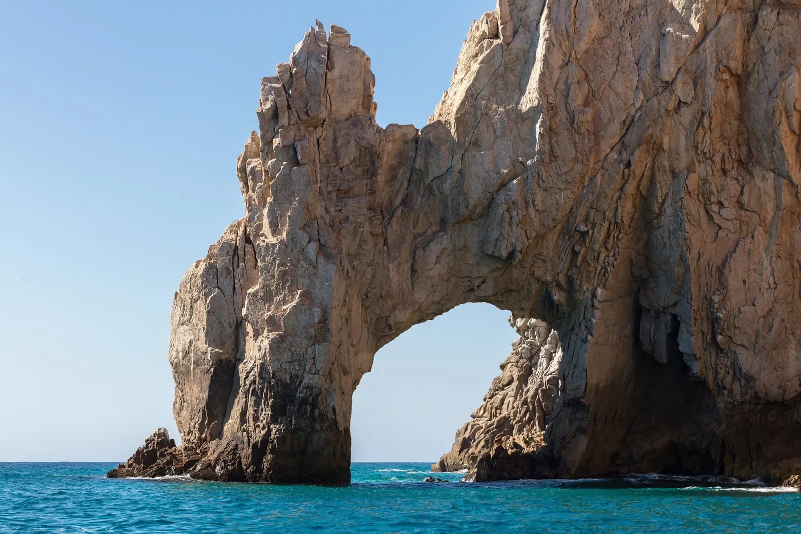 El Arco, the rock arch at Land's End in Cabo San Lucas, rising from turquoise water under a clear sky