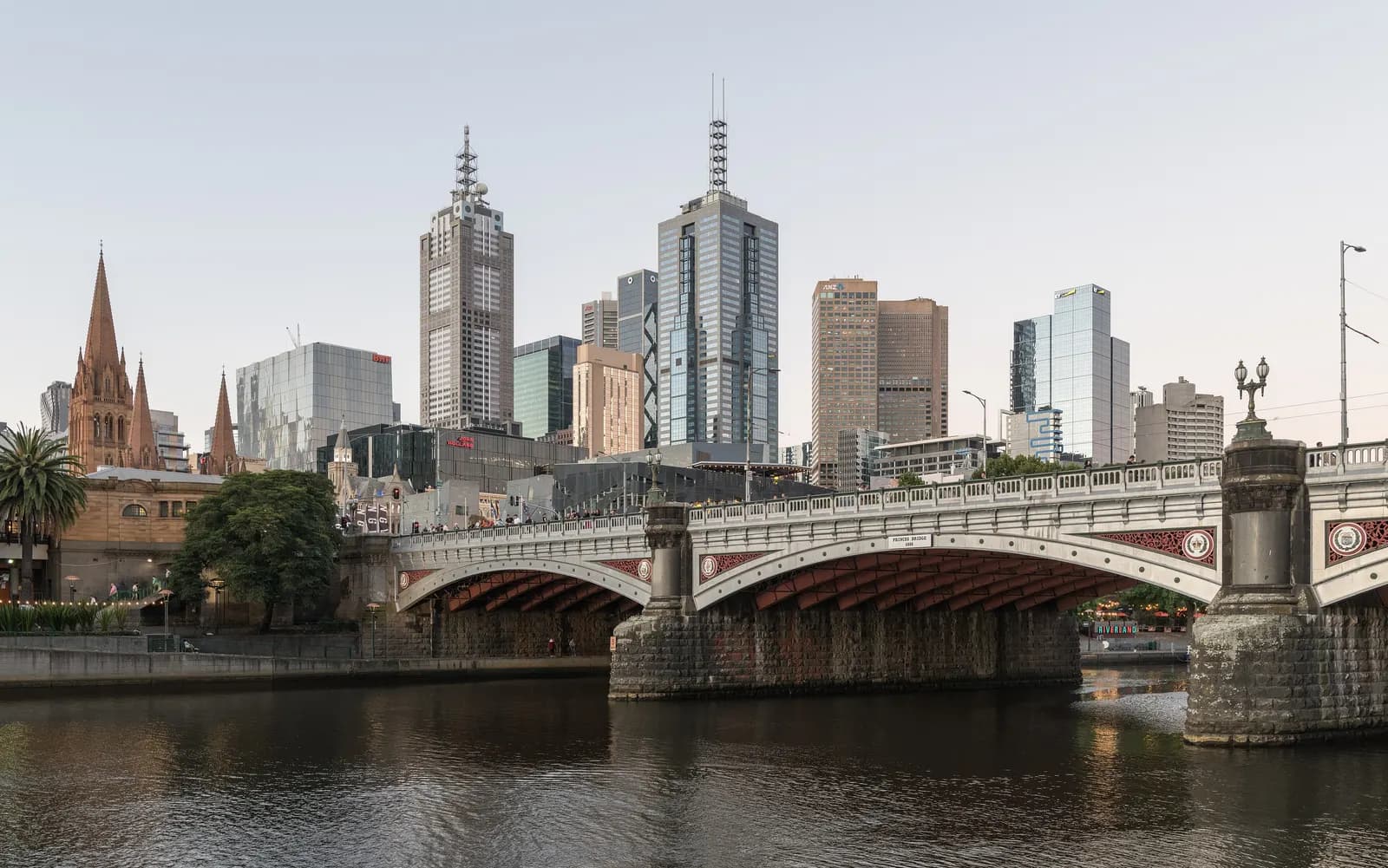 Princes Bridge over the Yarra River in Melbourne, with the spires of St Paul's Cathedral and the towers of the city centre behind it