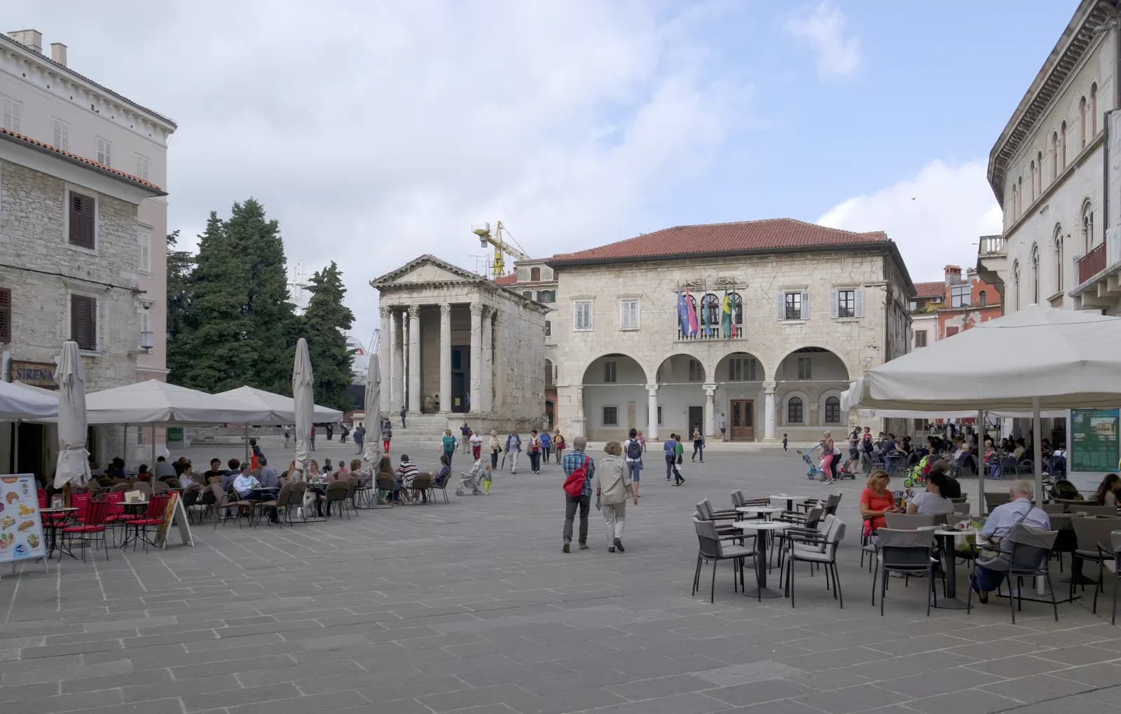 The Forum in Pula old town with the Roman Temple of Augustus, the arcaded town hall and café terraces on the square