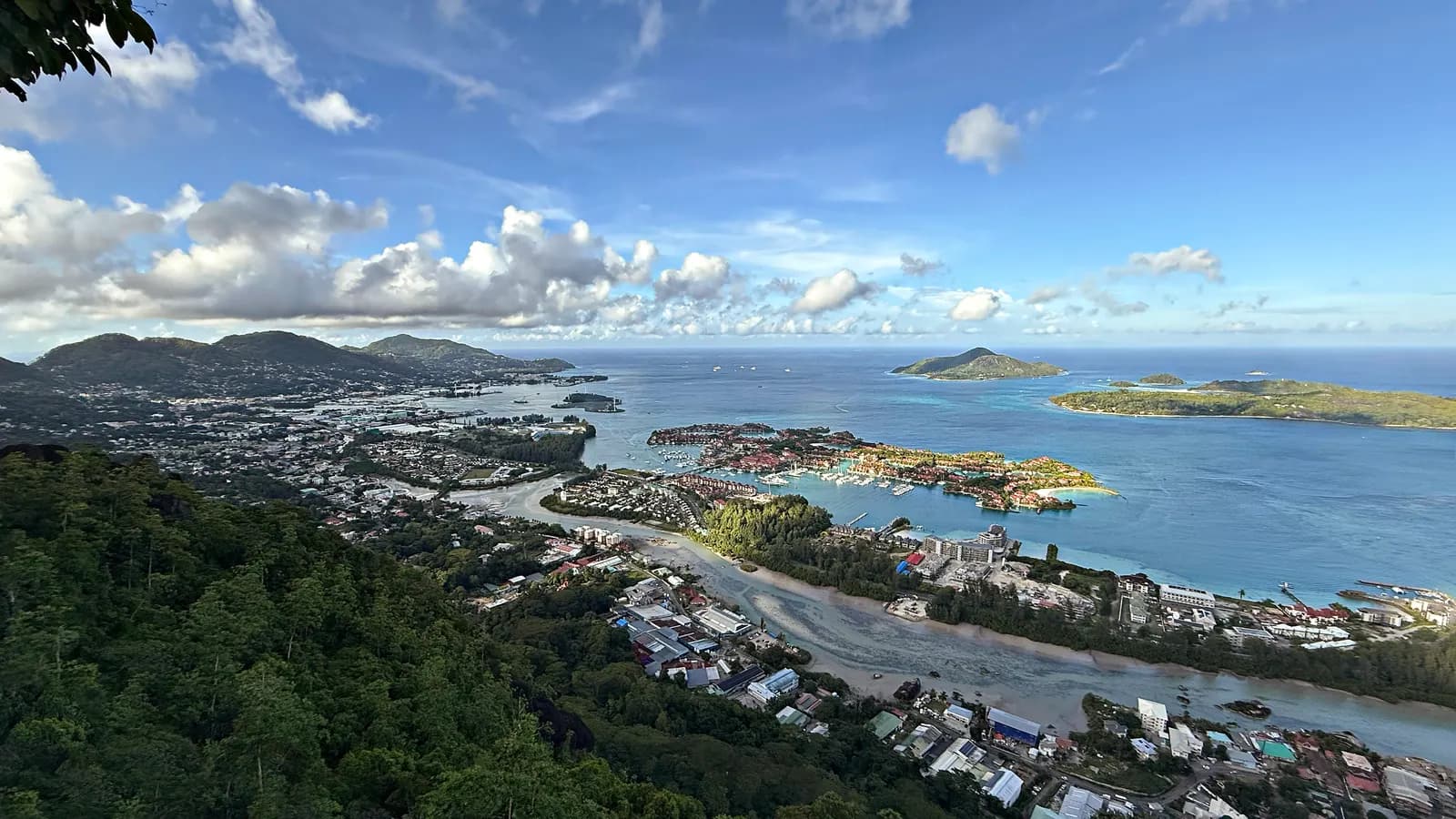 View from the hills over Victoria and Port Victoria on the east coast of Mahé, with the town, a marina on a reclaimed island and offshore islands