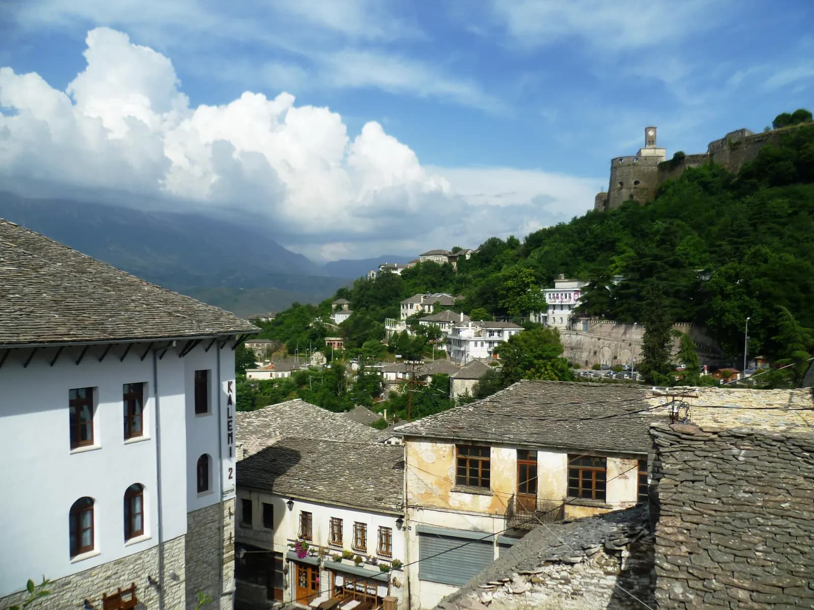 Stone-roofed Ottoman houses in Gjirokastër old town below the castle hill and its clock tower