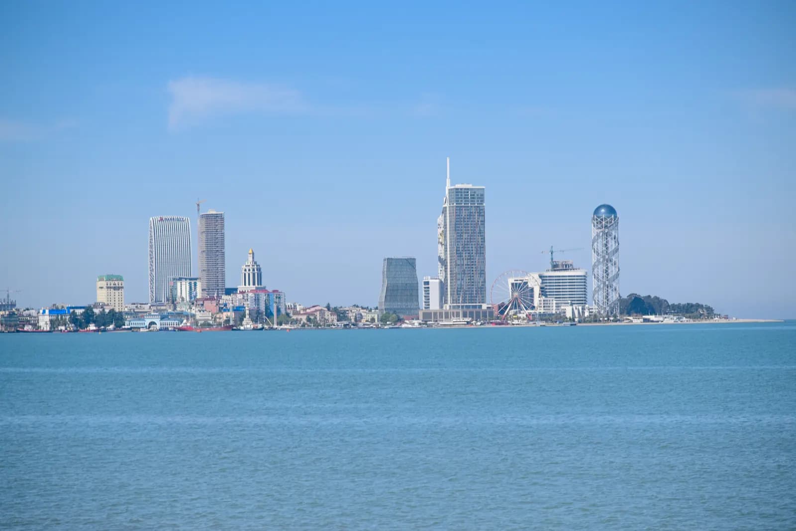 The Batumi skyline seen across the Black Sea, with high-rise towers along the shore and the Alphabetic Tower at the right