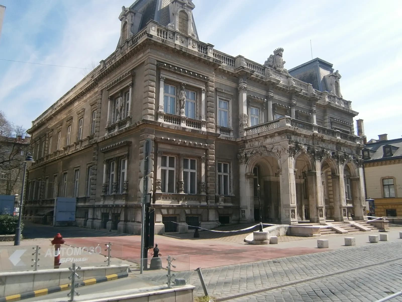 The Károlyi Palace on Pollack Mihály tér in the Palace District, a stone palace with an arched entrance and a cobbled square in front