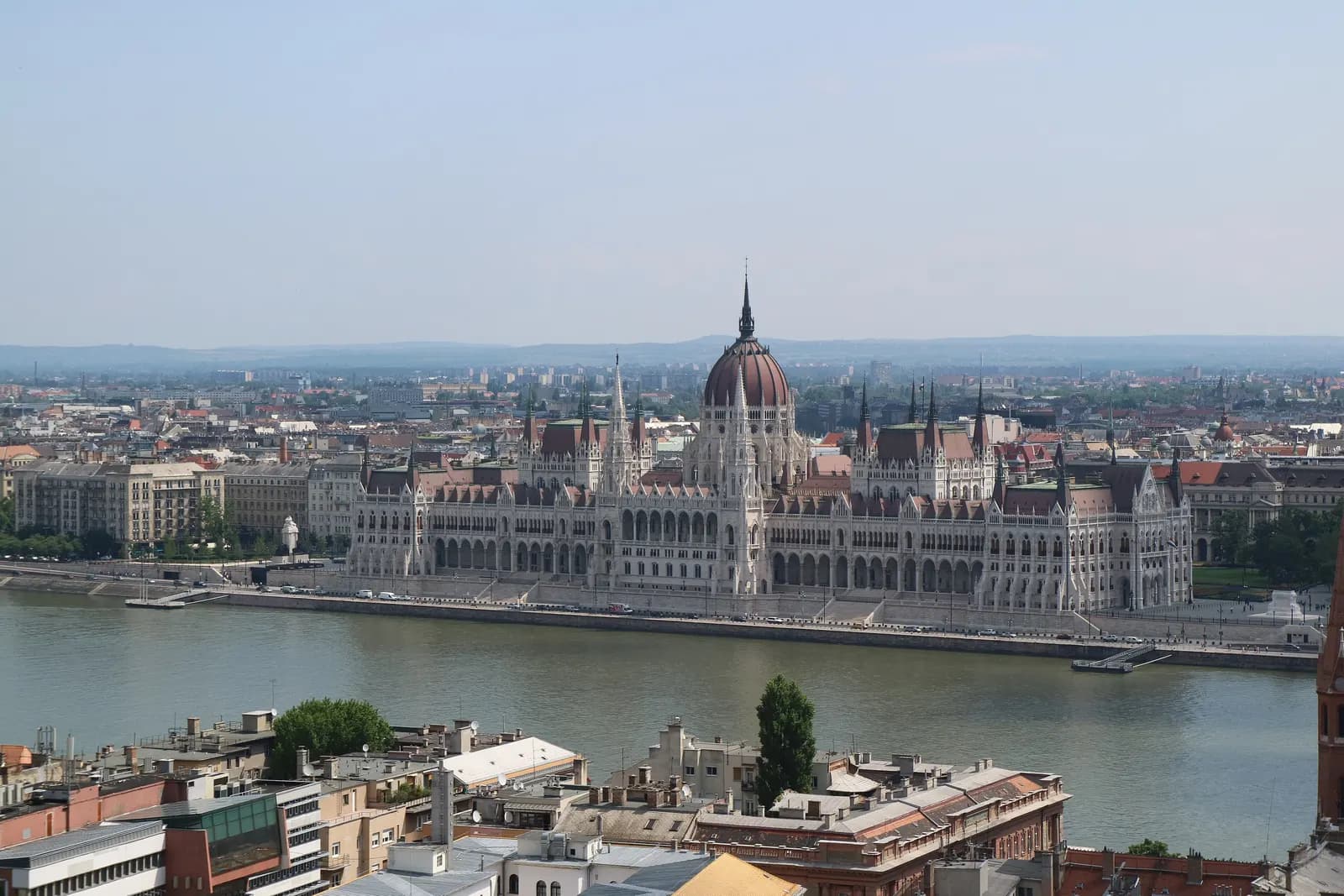 The Hungarian Parliament on the Pest bank of the Danube, seen from Buda Castle across the river and the rooftops of the Buda side on a clear day