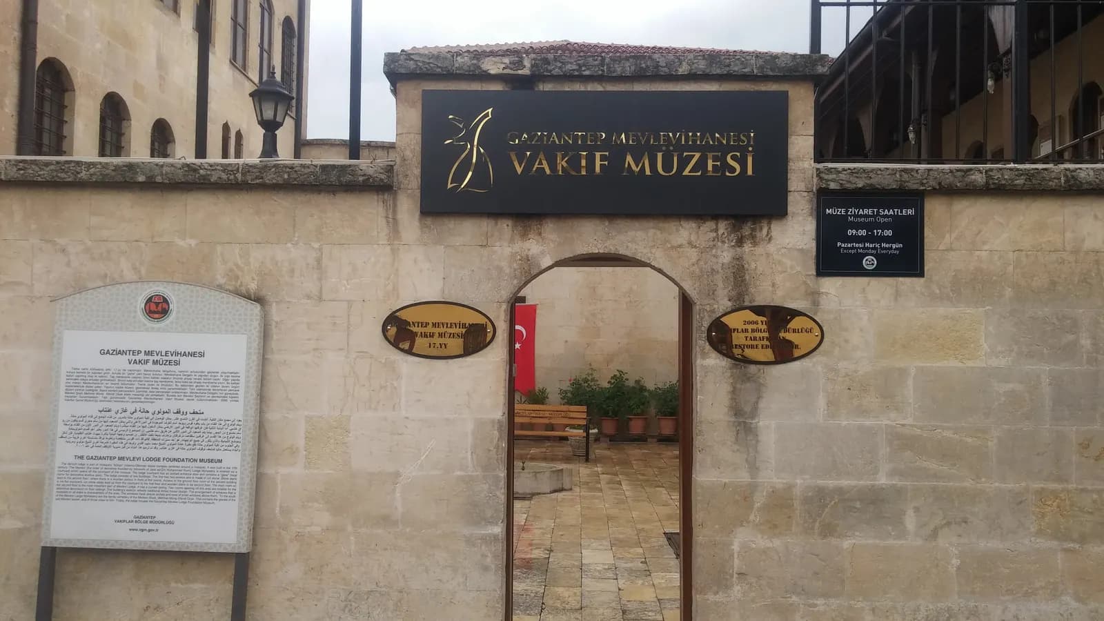 The stone gateway of the Gaziantep Mevlevi Lodge Foundation Museum, with its name sign above an arched doorway
