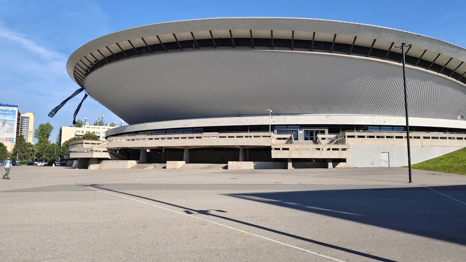 The Spodek arena in Katowice, a saucer-shaped concrete hall raised above a wide paved forecourt