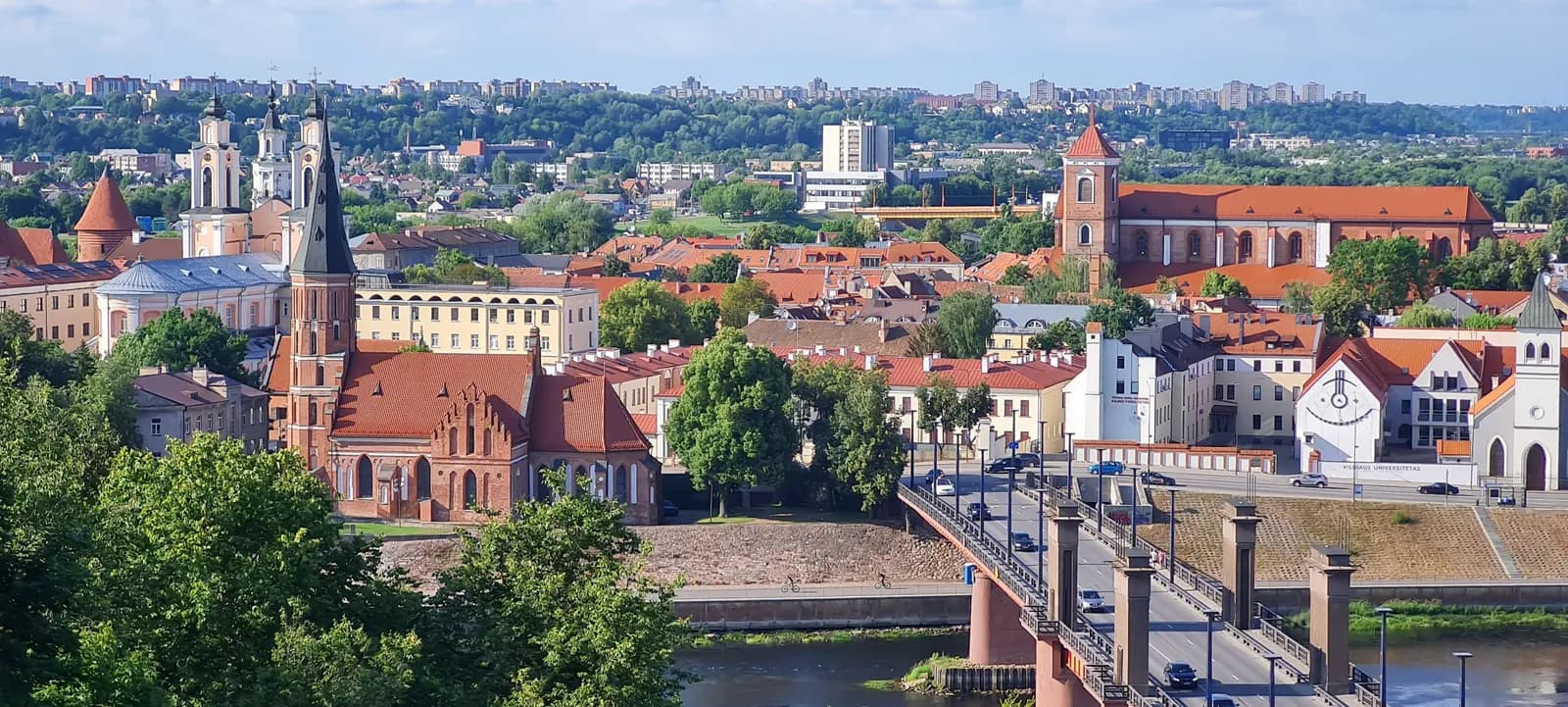 Kaunas Old Town seen from Aleksotas hill: brick churches, red roofs and the bridge over the Nemunas