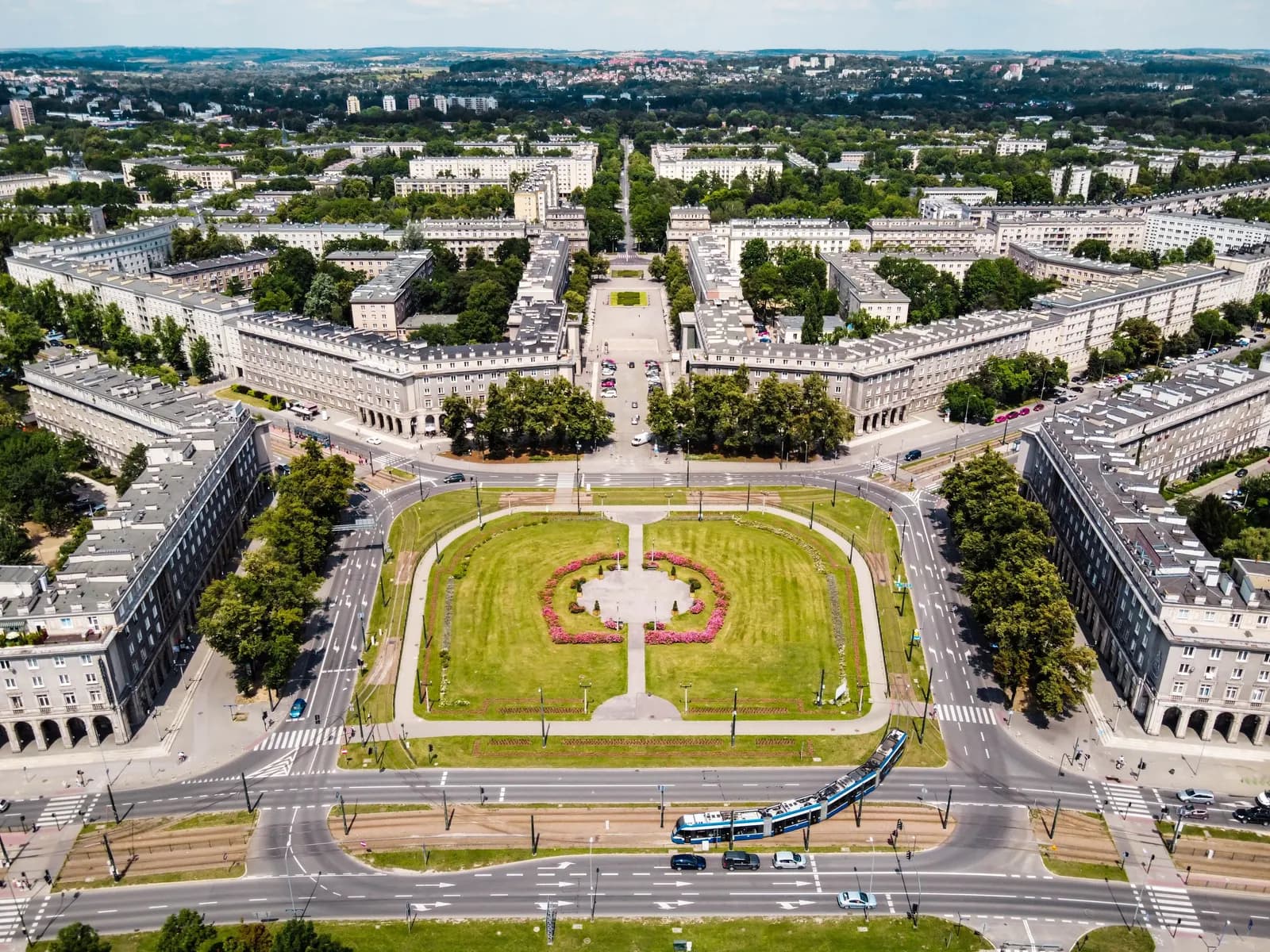 Aerial view of Central Square in Nowa Huta, a green lawn framed by symmetrical apartment blocks and avenues fanning out to the north