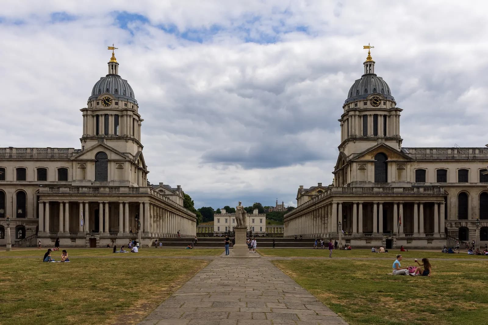 The twin domes of the Old Royal Naval College in Greenwich either side of the lawn, with the Queen's House in the distance