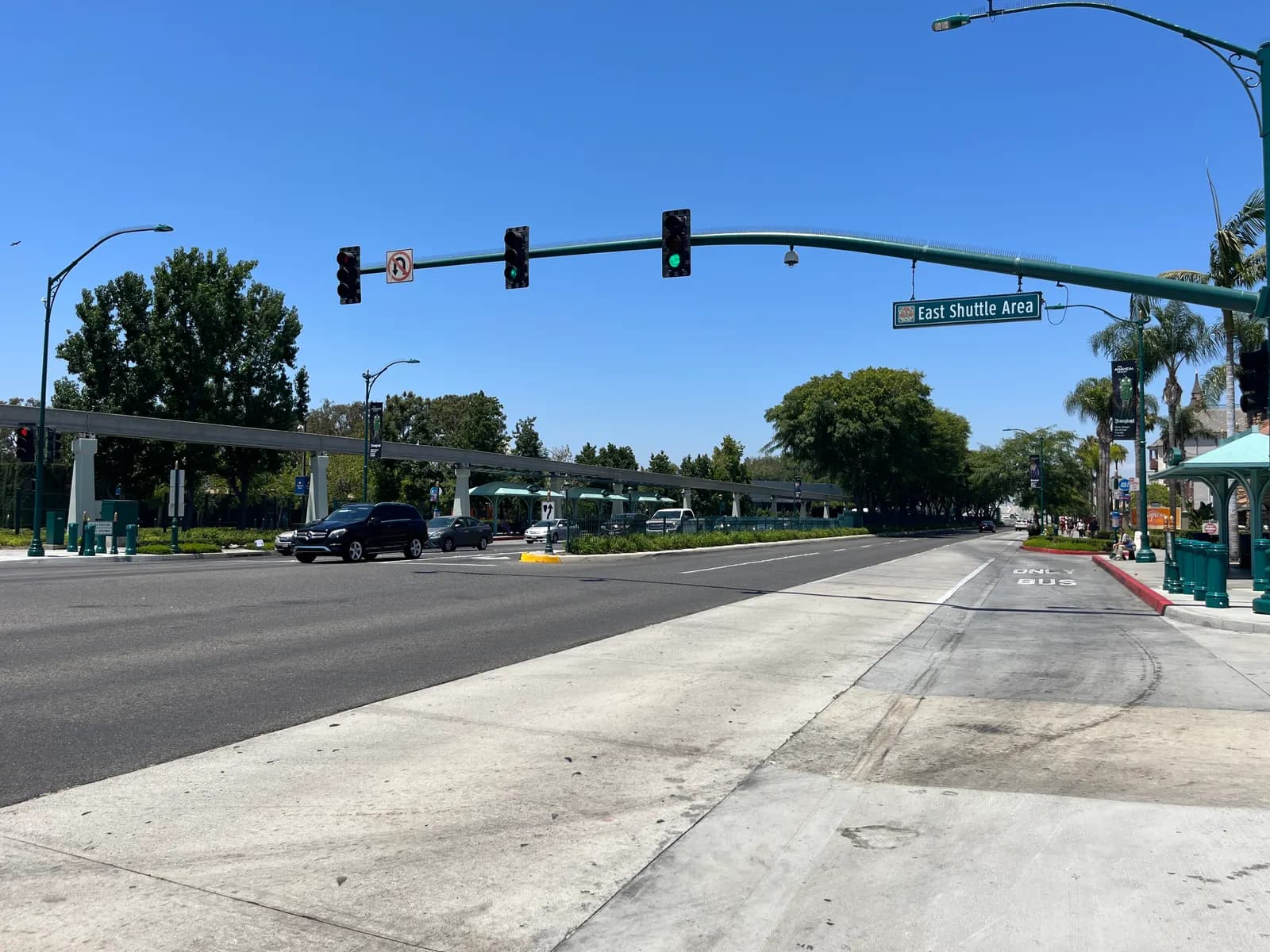 Harbor Boulevard beside the Disneyland Resort in Anaheim, with a bus lane, a sign for the East Shuttle Area and the monorail track behind