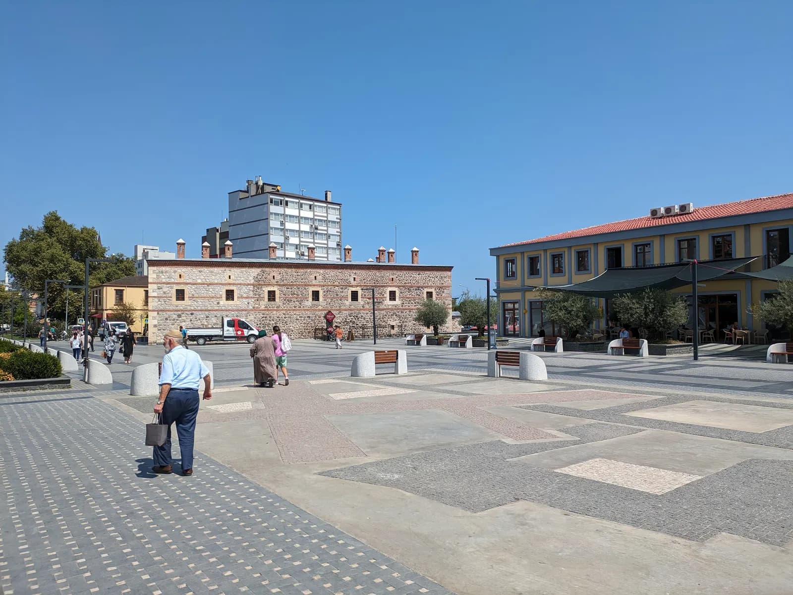 The paved Saathane Square in Samsun with low historic buildings and a café terrace on its far side