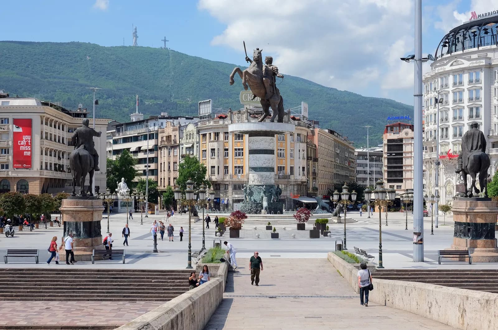 The Stone Bridge in Skopje leading to Macedonia Square, with the warrior on horseback statue, hotels and Mount Vodno behind